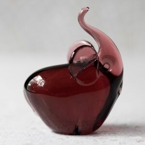 Purple glass elephant figurine with trunk curled up unknown maker 3.5" x 2.75"